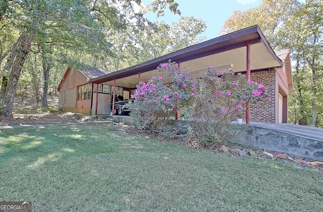 view of side of property with a garage and a yard