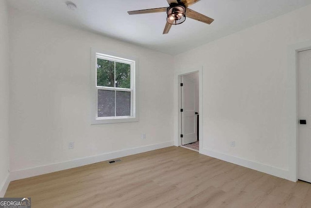 empty room featuring ceiling fan and light hardwood / wood-style flooring