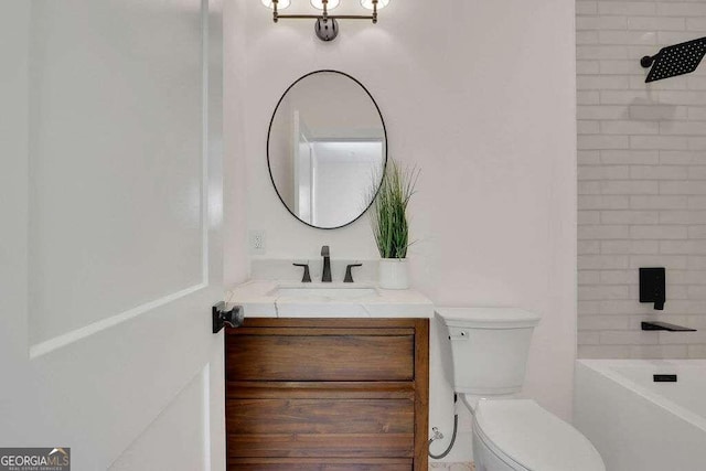 full bathroom featuring toilet, vanity, and tiled shower / bath