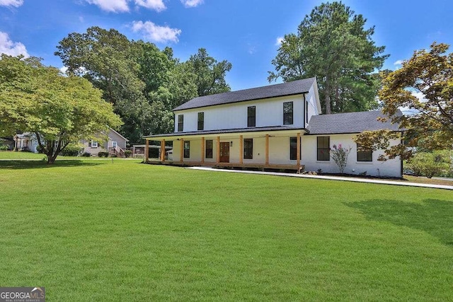 view of front of home featuring a front yard and covered porch