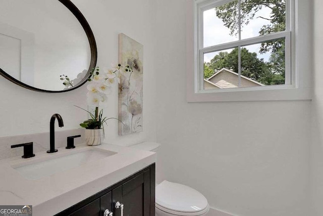 bathroom featuring vanity and toilet