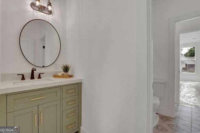 bathroom with toilet and vanity