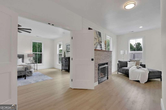 living room with ceiling fan and light hardwood / wood-style floors