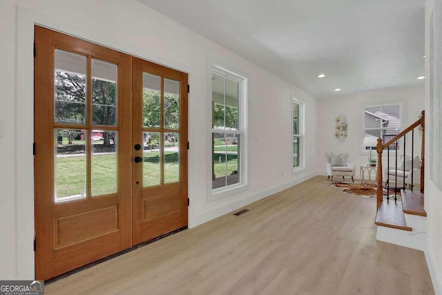 doorway to outside featuring french doors and light hardwood / wood-style floors