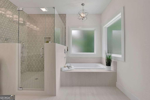 bathroom featuring an inviting chandelier, tile patterned floors, and plus walk in shower