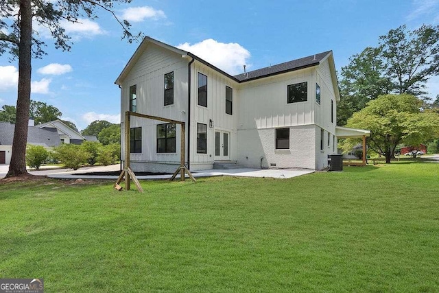 back of house featuring a patio and a lawn