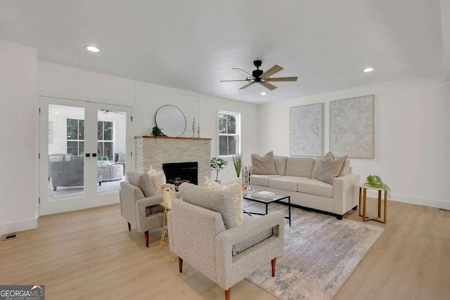 living room featuring light hardwood / wood-style flooring and ceiling fan