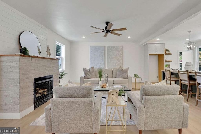 living room featuring ceiling fan and light wood-type flooring