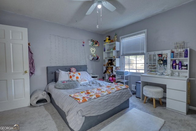 carpeted bedroom with a textured ceiling and ceiling fan