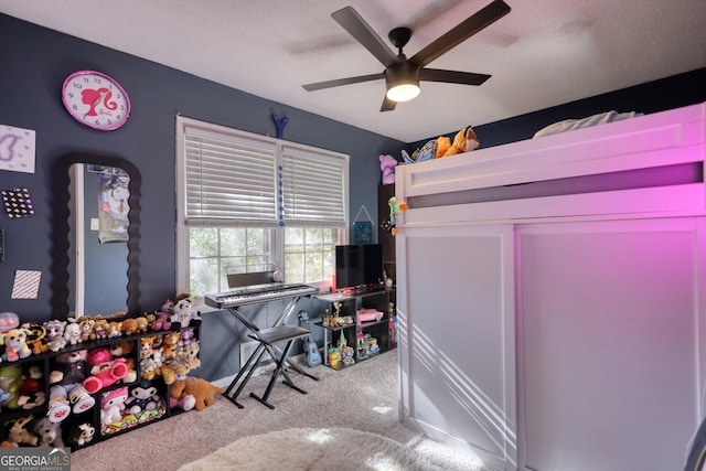 bedroom with ceiling fan, carpet, and a textured ceiling