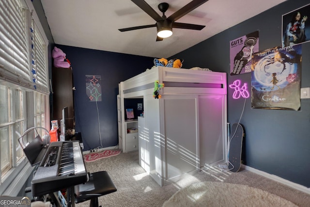 carpeted bedroom with ceiling fan and multiple windows