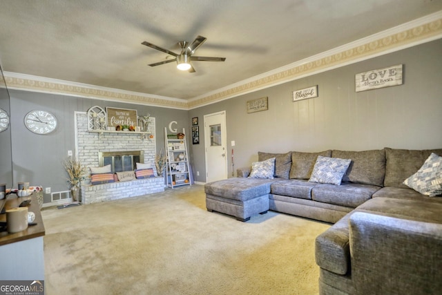 carpeted living room with ceiling fan, a fireplace, a textured ceiling, and ornamental molding