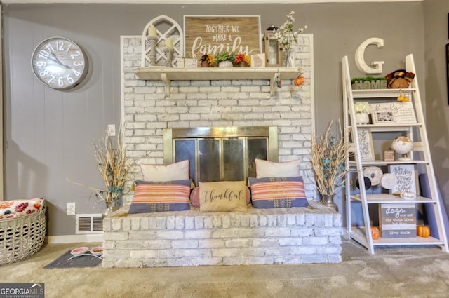 sitting room featuring carpet floors and a brick fireplace