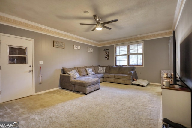 carpeted living room featuring ceiling fan and ornamental molding