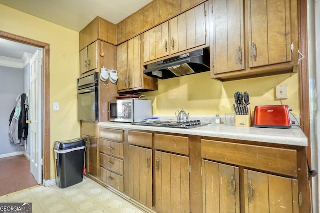 kitchen featuring black oven, stainless steel gas stovetop, and crown molding