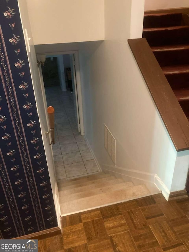 stairway with parquet flooring