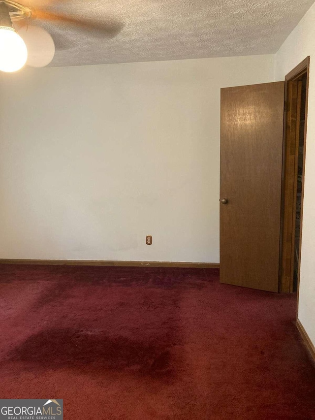 carpeted spare room featuring a textured ceiling