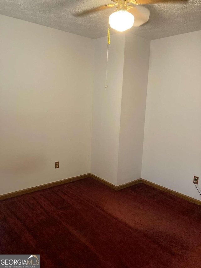 unfurnished room with a textured ceiling, carpet flooring, and ceiling fan