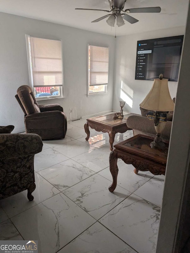 sitting room with ceiling fan and plenty of natural light