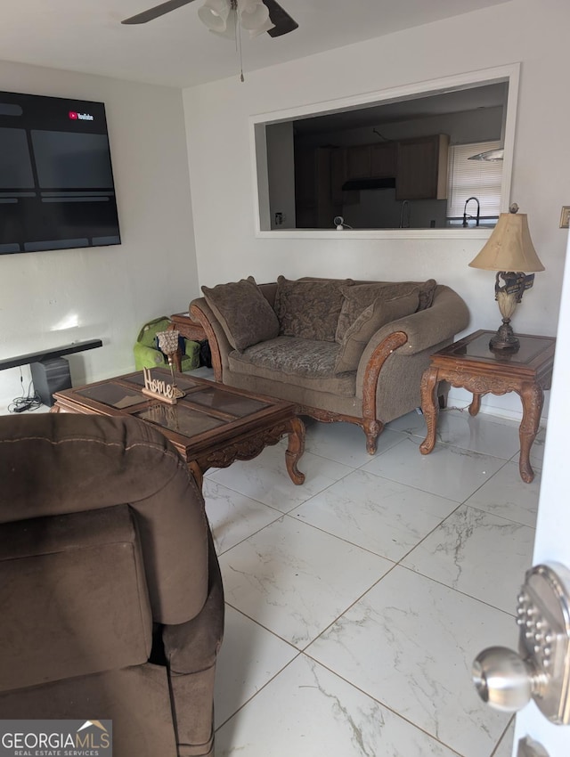 living room featuring ceiling fan and sink