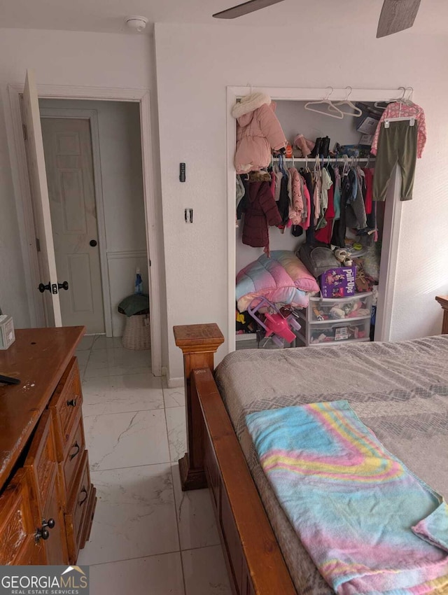 bedroom featuring ceiling fan and a closet