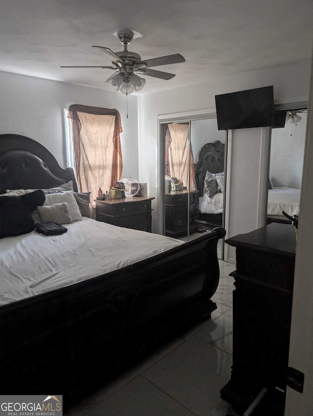 tiled bedroom with ceiling fan