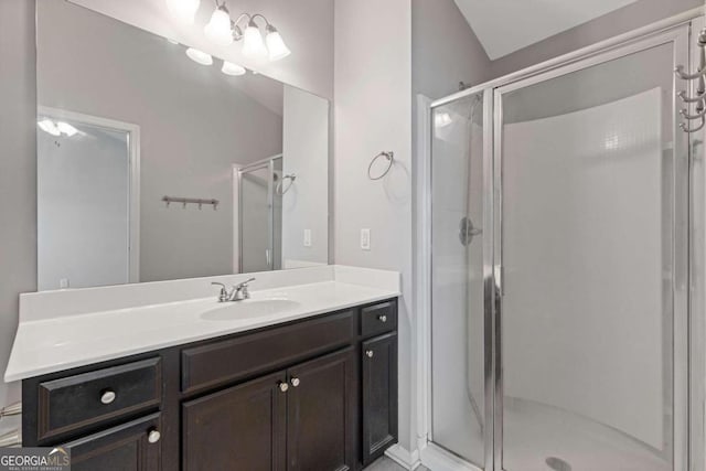 bathroom featuring vanity and an enclosed shower