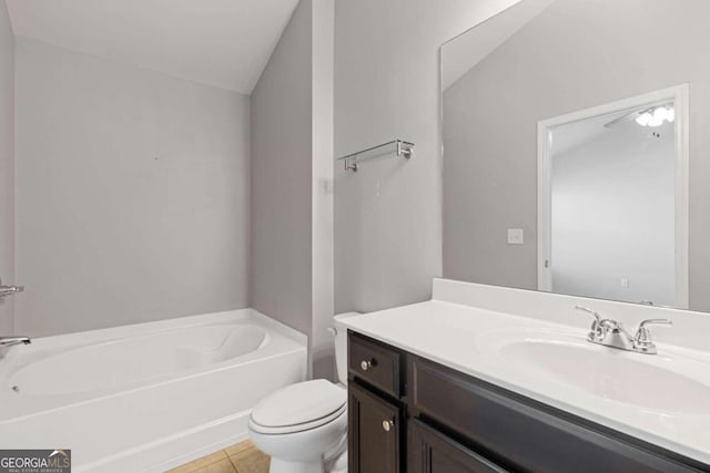 bathroom featuring lofted ceiling, toilet, a tub, tile patterned flooring, and vanity