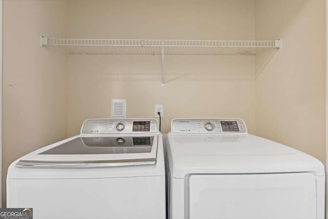 laundry room featuring washer and clothes dryer