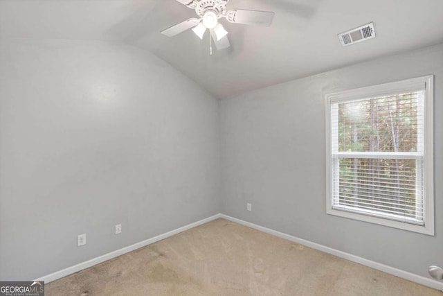 unfurnished room featuring lofted ceiling, light colored carpet, and ceiling fan