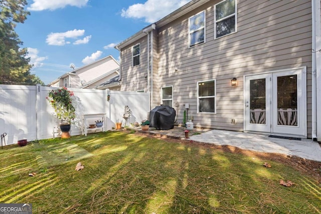 back of house with a patio and a yard