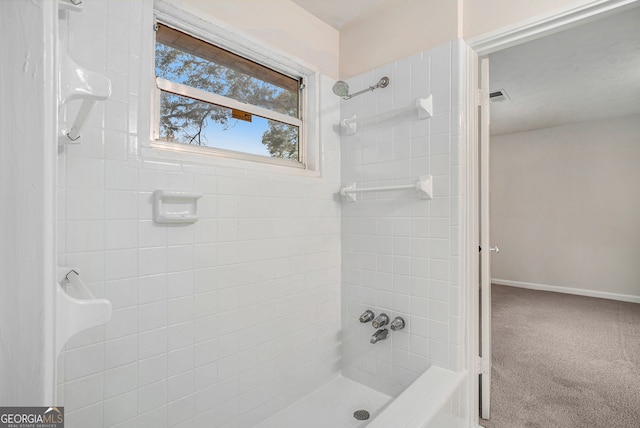 bathroom with tiled shower