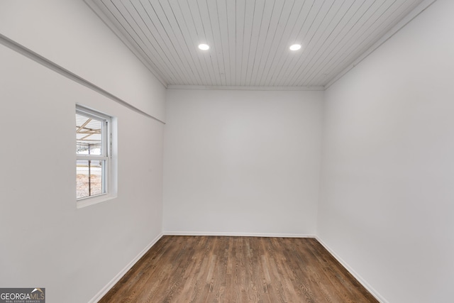 unfurnished room with dark hardwood / wood-style flooring, wood ceiling, and ornamental molding