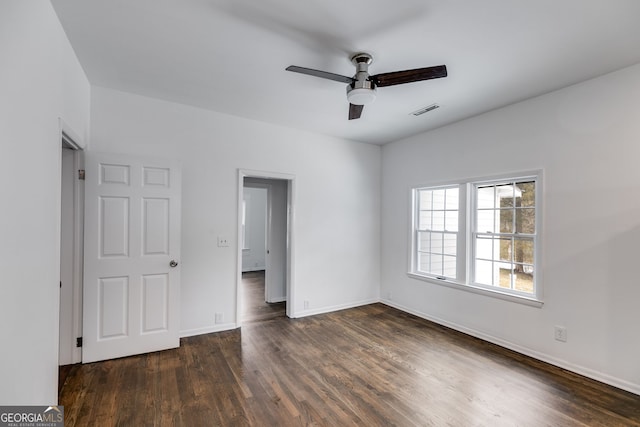 unfurnished room featuring ceiling fan and dark hardwood / wood-style flooring