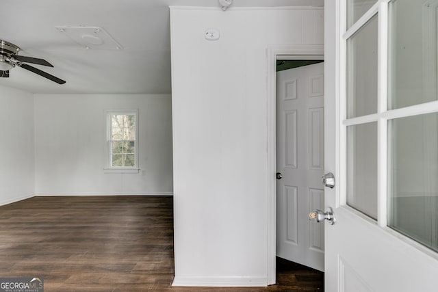 kitchen featuring baseboards, a sink, dark wood-style flooring, and white cabinetry