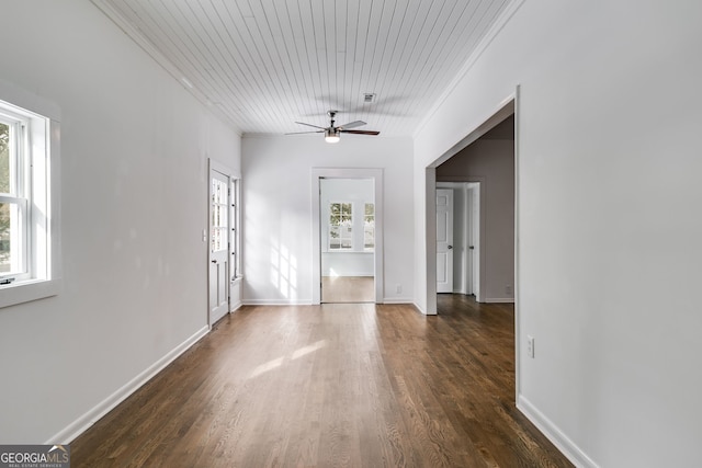 empty room with ceiling fan, dark hardwood / wood-style flooring, and ornamental molding