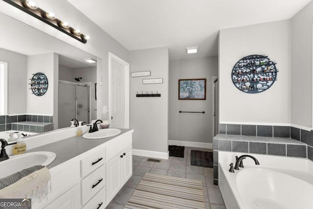 bathroom featuring vanity, tile patterned floors, and separate shower and tub