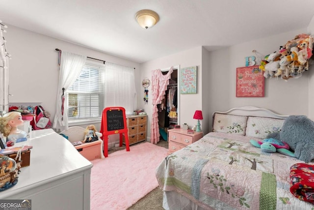 carpeted bedroom featuring a closet and a spacious closet