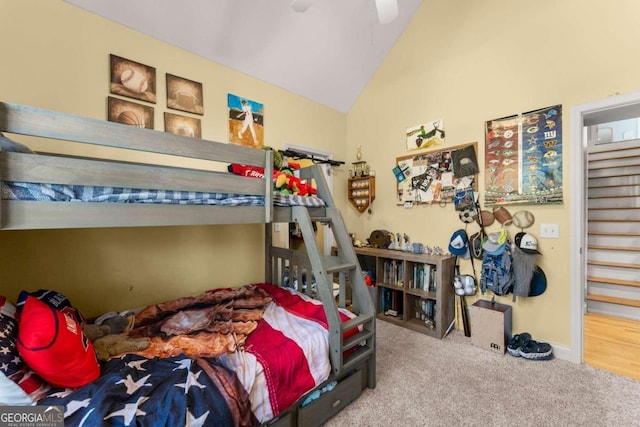 carpeted bedroom with ceiling fan and lofted ceiling