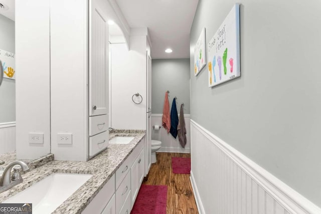 bathroom featuring vanity, hardwood / wood-style flooring, and toilet