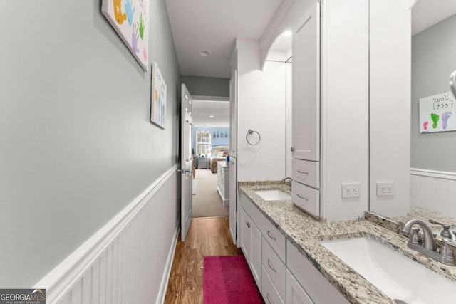 bathroom featuring hardwood / wood-style flooring and vanity