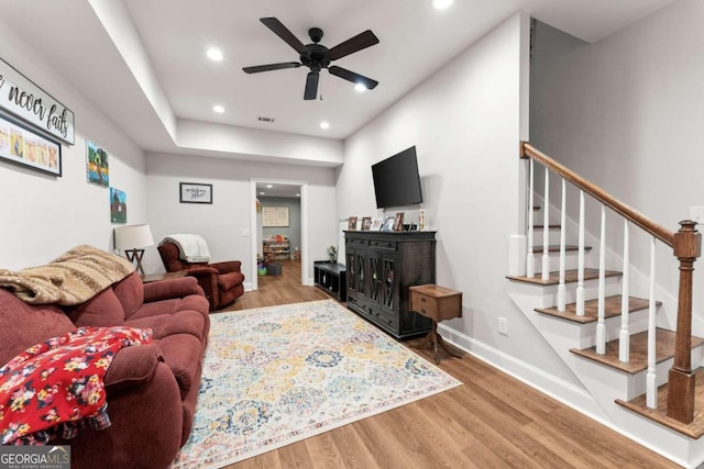 living room featuring hardwood / wood-style flooring and ceiling fan