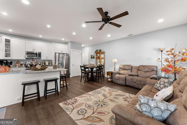 living room with dark hardwood / wood-style floors and ceiling fan