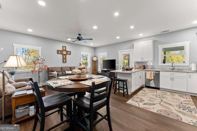 dining area featuring plenty of natural light, ceiling fan, sink, and dark hardwood / wood-style flooring