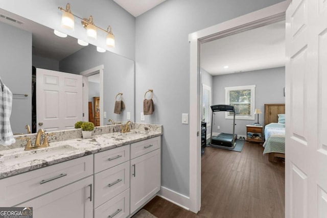 bathroom with hardwood / wood-style floors and vanity