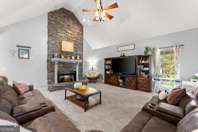 carpeted living room with ceiling fan, a stone fireplace, and high vaulted ceiling