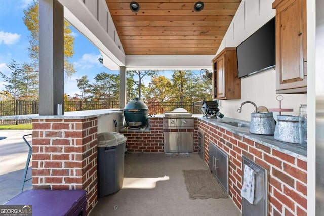 view of patio / terrace featuring a grill, sink, and exterior kitchen