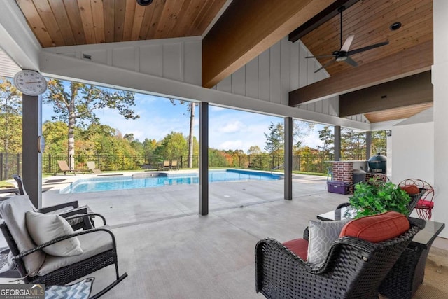 view of patio / terrace featuring ceiling fan and a fenced in pool