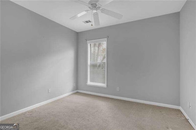 unfurnished room with ceiling fan and light carpet