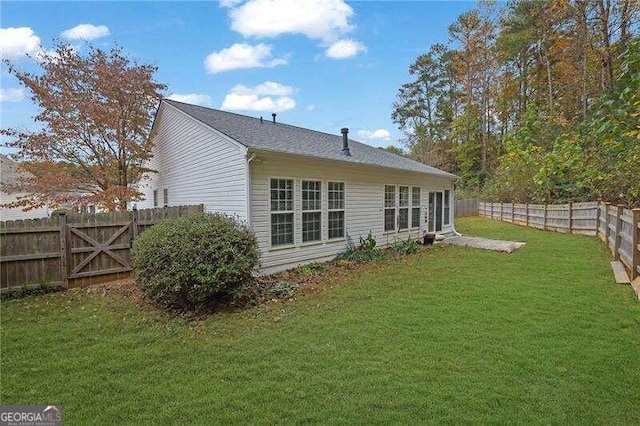 rear view of house with a lawn